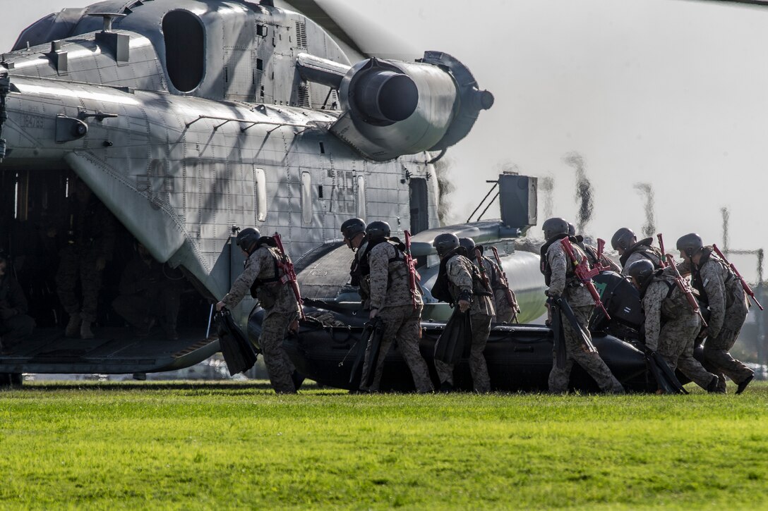 U.S. Marines with the Basic Reconnaissance Course carry a combat rubber raiding craft to a CH-53E Super Stallion helicopter to conduct helocasting training at Naval Amphibious Base Coronado, California, Oct. 29, 2019. BRC is one of the many courses taught by the staff at Reconnaissance Training Company, Advanced Infantry Training Battalion, School of Infantry - West. The course provides students with the basic knowledge of reconnaissance doctrine, concepts, and techniques with emphasis on amphibious entry and extraction, beach reconnaissance and reconnaissance patrolling skills. (Marine Corps photo by Lance Cpl. Andrew Cortez)
