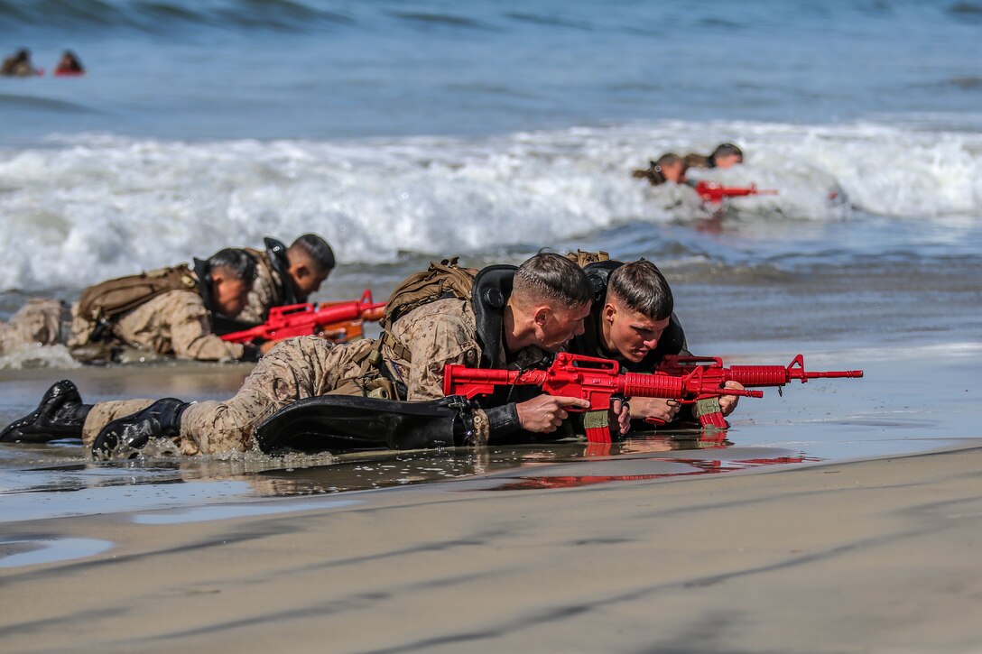 U.S. Marines with Basic Reconnaissance Course provide security on the beach during the clandestine landing and withdraw training at Naval Amphibious Base Coronado, California, Oct. 30, 2019. BRC is one of the many courses taught by the staff at Reconnaissance Training Company, Advanced Infantry Training Battalion, School of Infantry - West.  The course  provides students with the basic knowledge of reconnaissance doctrine, concepts, and techniques with emphasis on amphibious entry and extraction, beach reconnaissance and reconnaissance patrolling skills. (Marine Corps photo by Lance Cpl. Andrew Cortez)