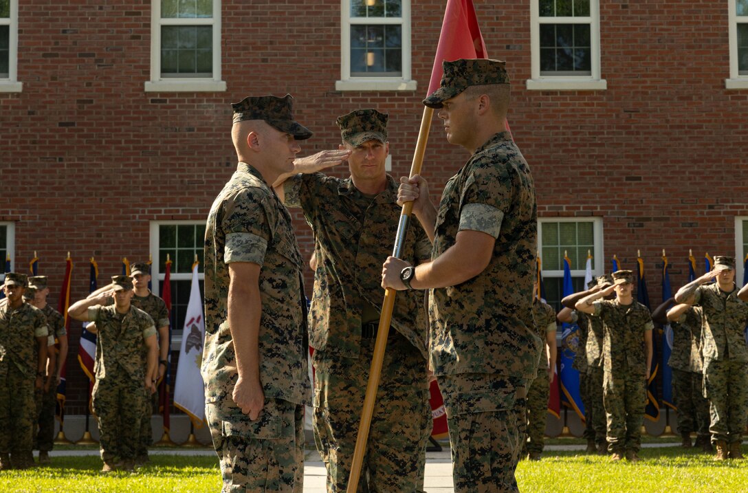 U.S. Marine Corps Capt. Patrick Vincent, right, the outgoing company commander of Headquarters Battalion, 2d Marine Division, transfers the guidon to Capt. Brock Yackey during a change of command ceremony on Camp Lejeune, North Carolina, July 13, 2023. During the ceremony, Capt. Patrick Vincent, the outgoing company commander of Headquarters Battalion, relinquished command to Capt. Brock Yackey. (U.S. Marine Corps photo by Lance Cpl. Daysia McCree)