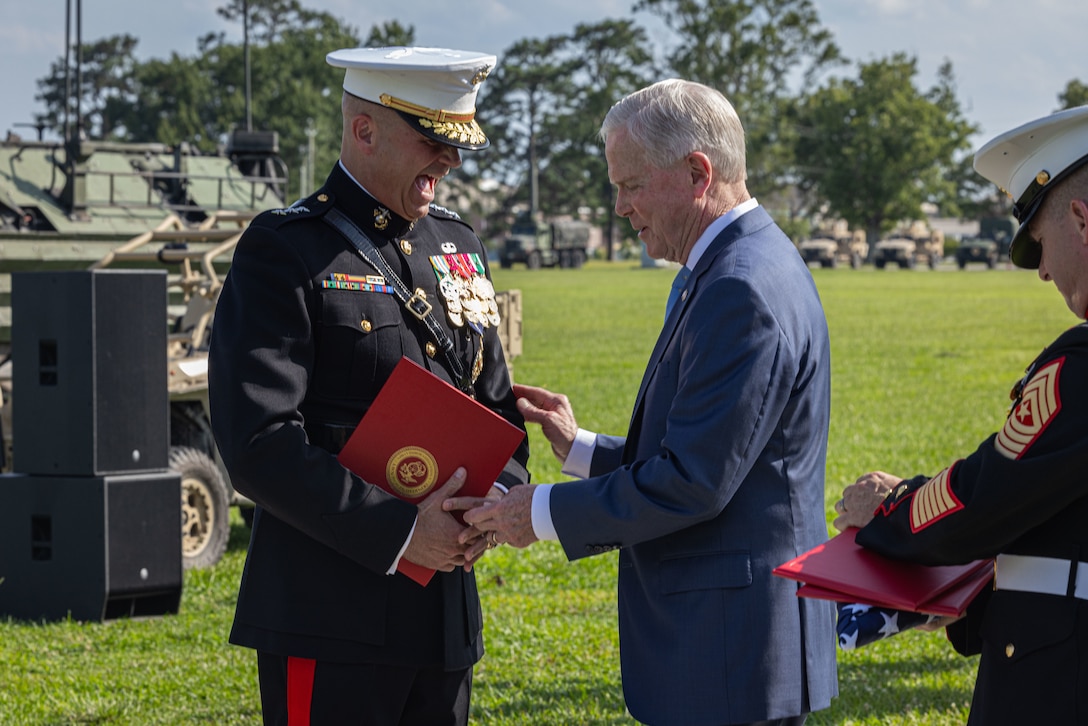 U.S. Marine Corps Retired General James F. Amos, 35th Commandant of the Marine Corps, presents Lt. Gen. David J. Furness, the Deputy Commandant for Plans, Policy and Operations, Headquarters, United States Marine Corps, the distinguished service medal during his retirement ceremony on Camp Lejeune, North Carolina, July 21, 2023. Furness is retiring after 36 years of honorable and faithful service. (U.S. Marine Corps photo by Lance Cpl. Averi Rowton)