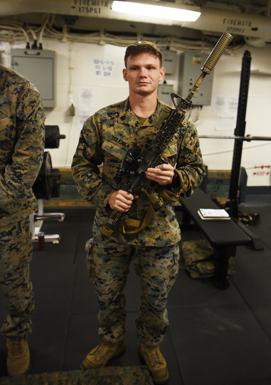 A Marine holds a weapon.