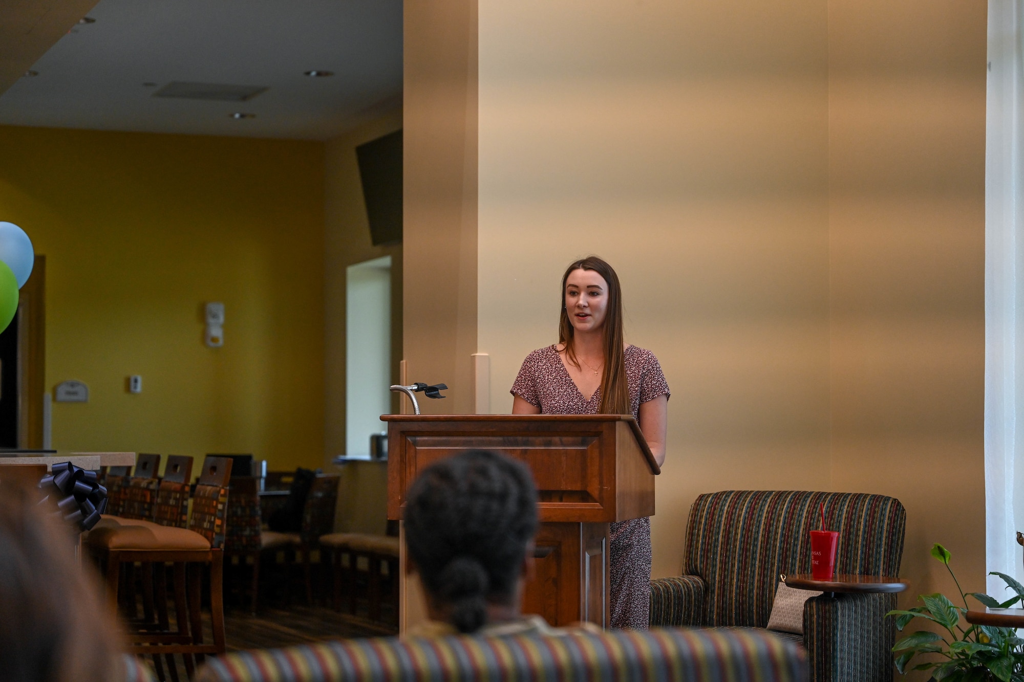 A woman speaks at a podium