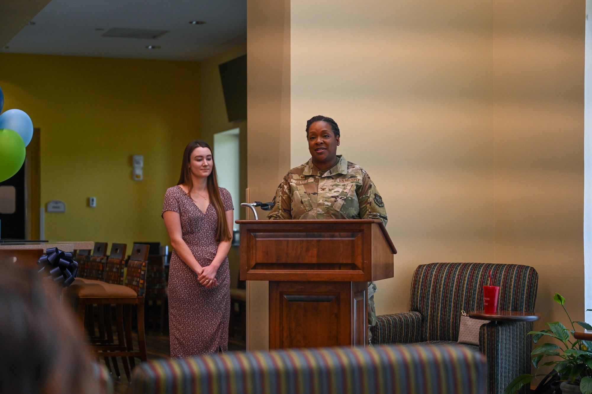 A woman in uniform speaks at a podium