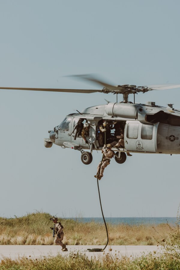 U.S. Marines with Force Company, 2d Reconnaissance Battalion, 2d Marine Division, under tactical control of Task Force 61/2, fast rope out of a MH-60S helicopter in Souda Bay, Greece on July 19, 2023. Task Force 61/2.5 provides naval and joint force commanders with dedicated multi-domain reconnaissance and counter reconnaissance (RXR) capabilities. (U.S. Marine Corps photo by Lance Cpl. Emma Gray)