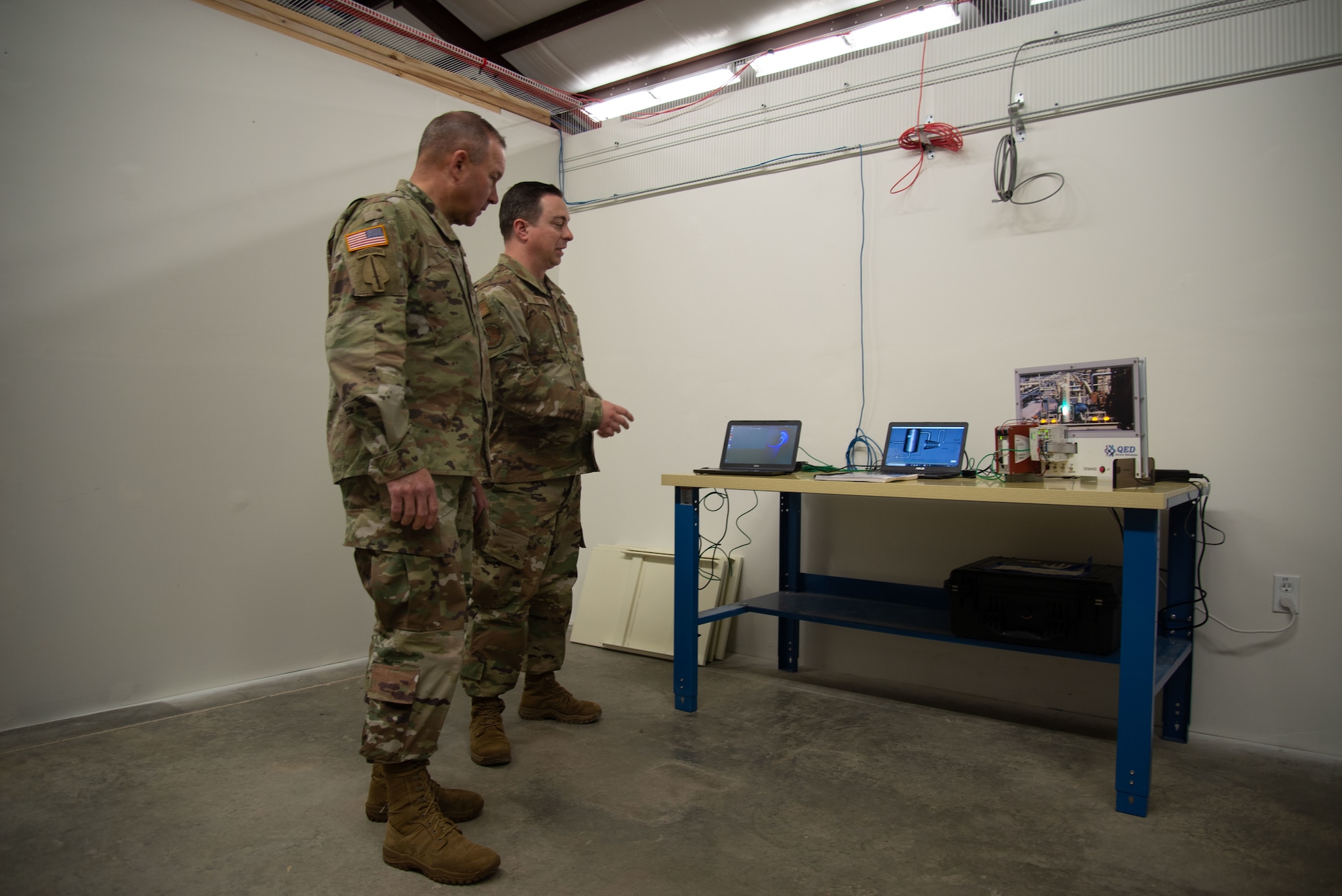 Maj. Gen. Anthony Hale, Commander, U.S. Army Center of Excellence and Fort Huachuca, listens as 1st Lt. Aaron Rutten, 175th Cyber Operations Group, Maryland Air National Guard demonstrates key ideas of cyber protection while on a tour on Camp Shelby Joint Forces Training Center, Mississippi, April 22, 2023.