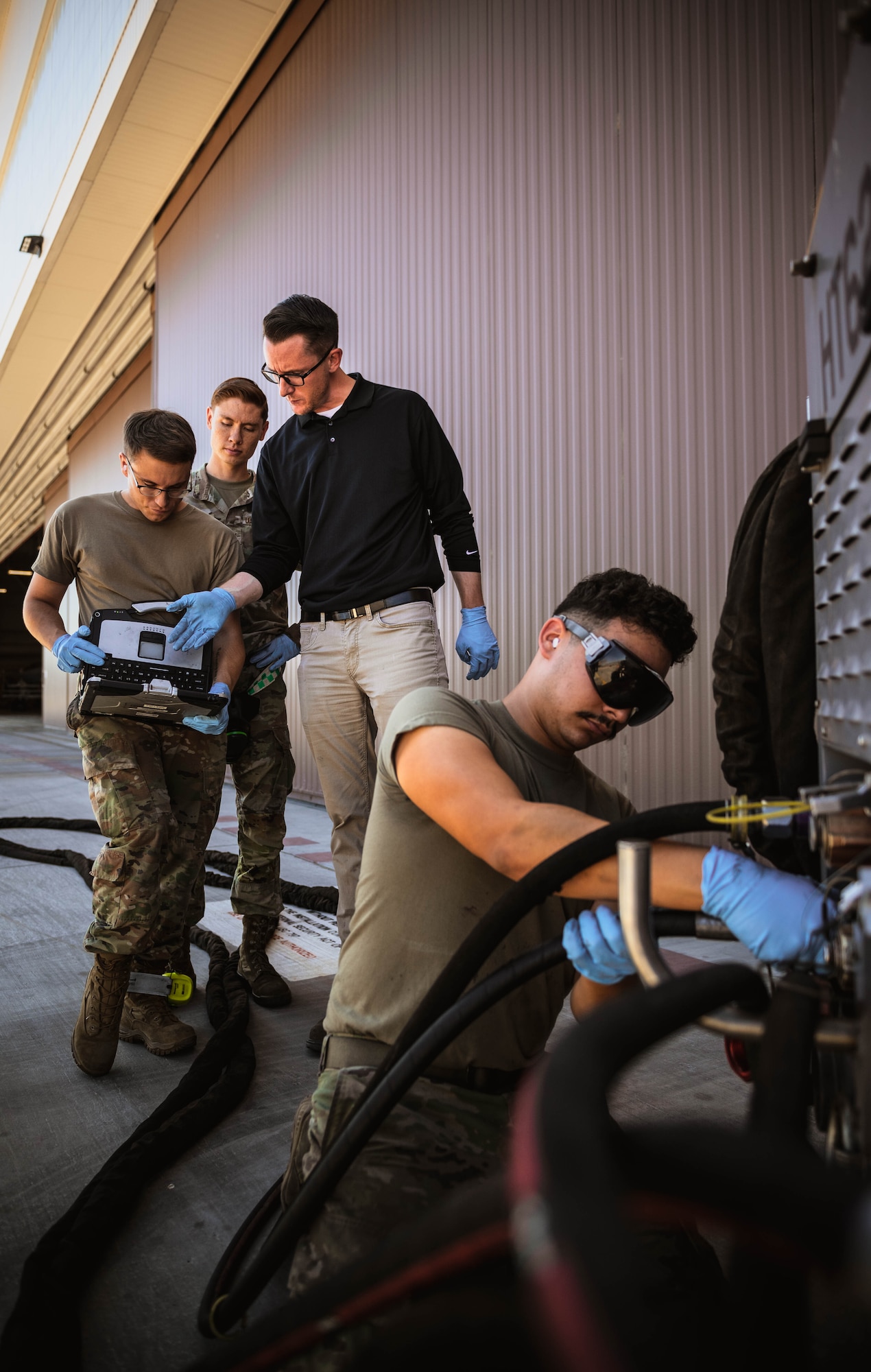 Nelson Bergemann (center), 56th Maintenance Group Air Force Engineering Technical Services avionics senior equipment specialist and U.S. Air Force Airmen assigned to the 308th Fighter Squadron, participate in diesel hydraulic cart training.
