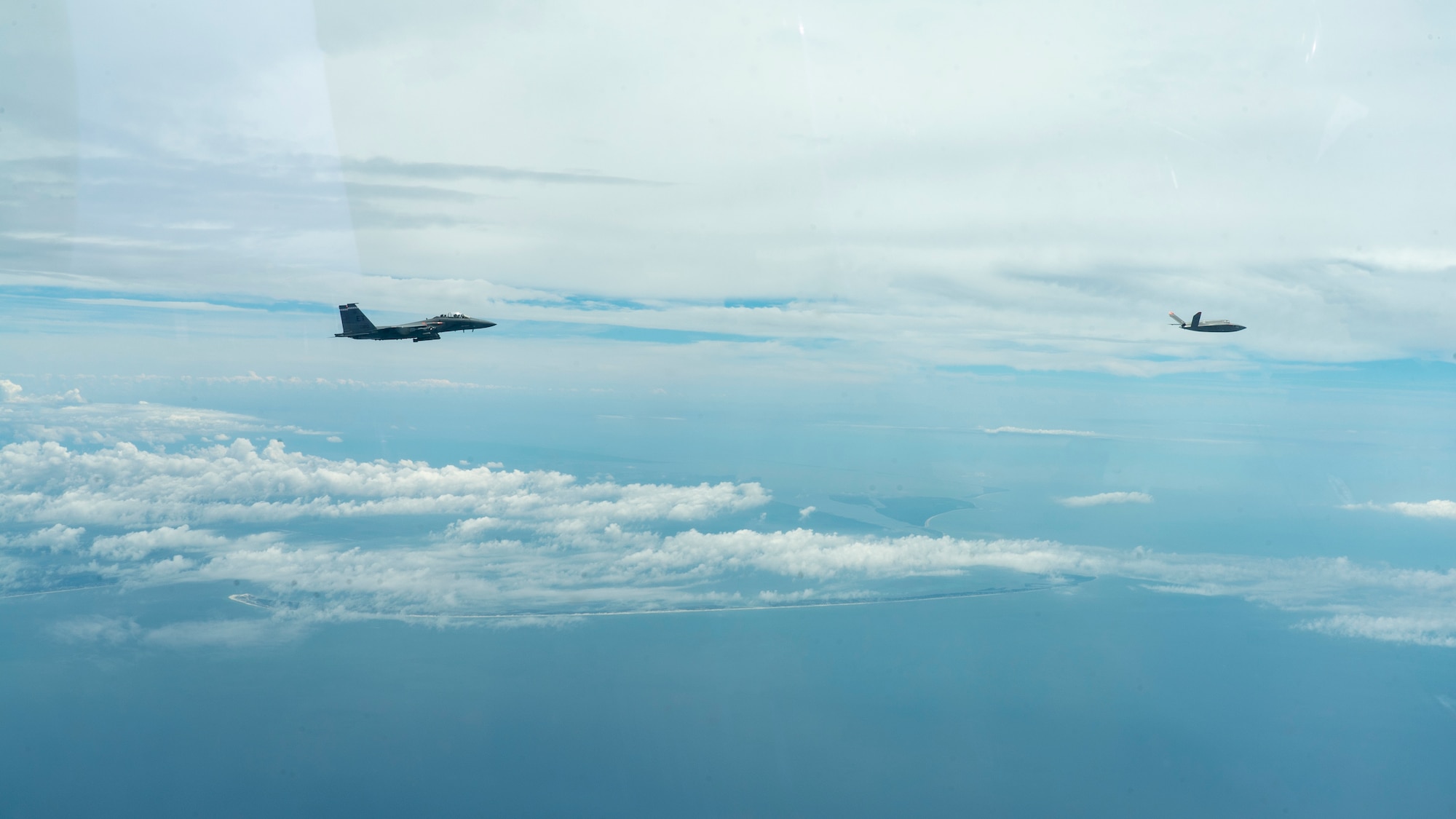 An F-15E Strike Eagle from the 96th Test Wing’s 40th Flight Test Squadron at Eglin AFB, Florida flies in formation with an XQ-58A Valkyrie flown by artificial intelligence agents developed by the Autonomous Air Combat Operations, or AACO, team from AFRL. The algorithms matured millions of hours in high fidelity AFSIM simulation events, 10 sorties on the X-62 VISTA, Hardware-in-the-Loop events with the XQ-58A, and ground test operations. (U.S. Air Force photo)