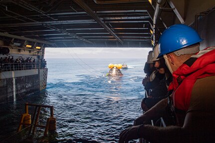 Sailors aboard amphibious transport dock ship USS John P. Murtha (LPD 26) train alongside NASA on proper line-handling for the Vehicle Advanced Demonstrator for Emergency Recovery, “VADR”, during Underway Recovery Test (URT) 10, July 26, 2023. VADR is a replica of the crew module that will be used during Artemis II. In preparation for NASA's Artemis II crewed mission, which will send four astronauts in Orion beyond the Moon, NASA and the U.S. Navy will conduct a series of tests to demonstrate and evaluate the processes, procedures, and hardware used in recovery operations for crewed lunar missions. The U.S. Navy has many unique capabilities that make it an ideal partner to support NASA, including its amphibious capabilities with the ability to embark helicopters, launch and recover small boats, three-dimensional air search radar and advanced medical facilities. (U.S. Navy Photo by Mass Communication Specialist 2nd Class Joshua Samoluk)
