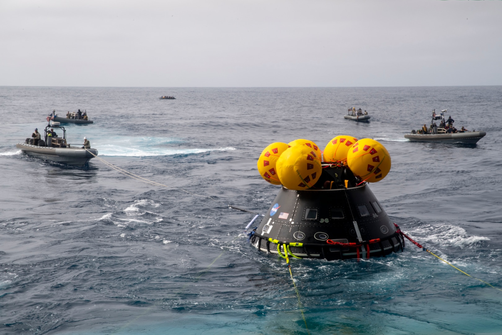 Sailors assigned to amphibious transport dock ship USS John P. Murtha (LPD 26) and Explosive Ordnance Disposal Expeditionary Support Unit 1 launch the Vehicle Advanced Demonstrator for Emergency Recovery, “VADR”, during Underway Recovery Test (URT) 10, July 27, 2023. VADR is a replica of the crew module that will be used during Artemis II. In preparation for NASA's Artemis II crewed mission, which will send four astronauts in Orion beyond the Moon, NASA and the U.S. Navy will conduct a series of tests to demonstrate and evaluate the processes, procedures, and hardware used in recovery operations for crewed lunar missions. The U.S. Navy has many unique capabilities that make it an ideal partner to support NASA, including its amphibious capabilities with the ability to embark helicopters, launch and recover small boats, three-dimensional air search radar and advanced medical facilities. (U.S. Navy Photo by Mass Communication Specialist 2nd Class Joshua Samoluk)