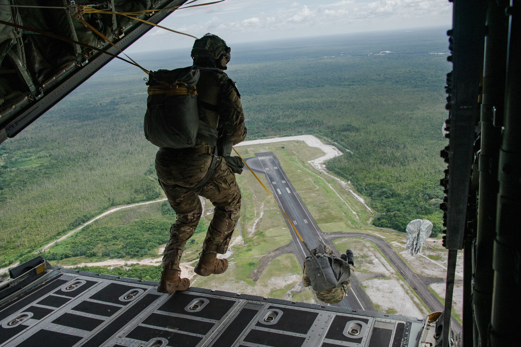 Tactical Air Control Party specialists with the 137th Special Operations Wing, Oklahoma National Guard, conduct a static line jump during TRADEWINDS23 Exercise over Air Base London, Guyana, July 18, 2023.