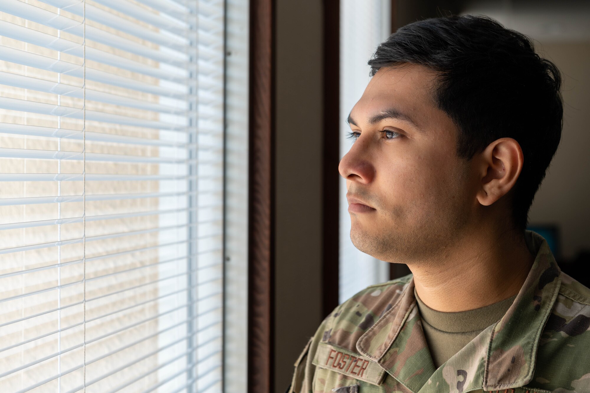 A service member poses for a portrait.
