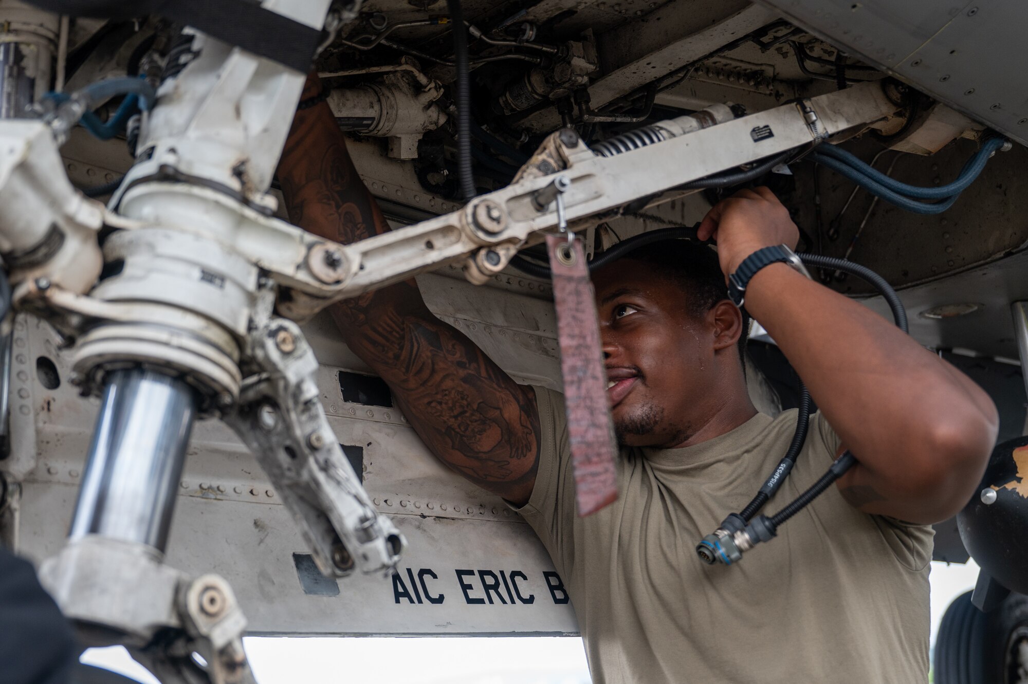 35th Fighter Generation Squadron aircraft electrical environmental systems technician, inspects the landing equipment of an F-16 Fighting Falcon