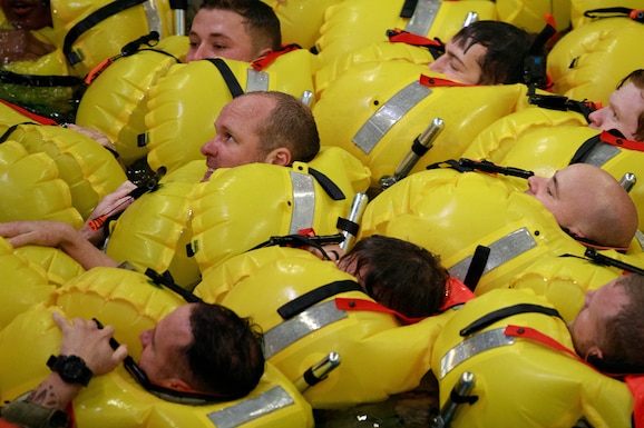 Soldiers from the 12th Combat Aviation Brigade prepare to swim towards a life raft as part of dunker training (helicopter over-water survival training) from October 18-19, Bremerhaven, Germany. The training was conducted at the RelyOn Nutec training center and is designed to teach anyone traveling on or over water, how to react before, during, and after a helicopter becomes submerged in water. 12CAB is a team of disciplined warfighting professionals trusted to execute precision aviation operations. Ensuring Soldiers successfully complete dunker training is one of the many ways the Griffin Brigade constantly improves their readiness to support missions across the European Command area of operations. (U.S. Army photo by Staff Sgt. Thomas Mort)