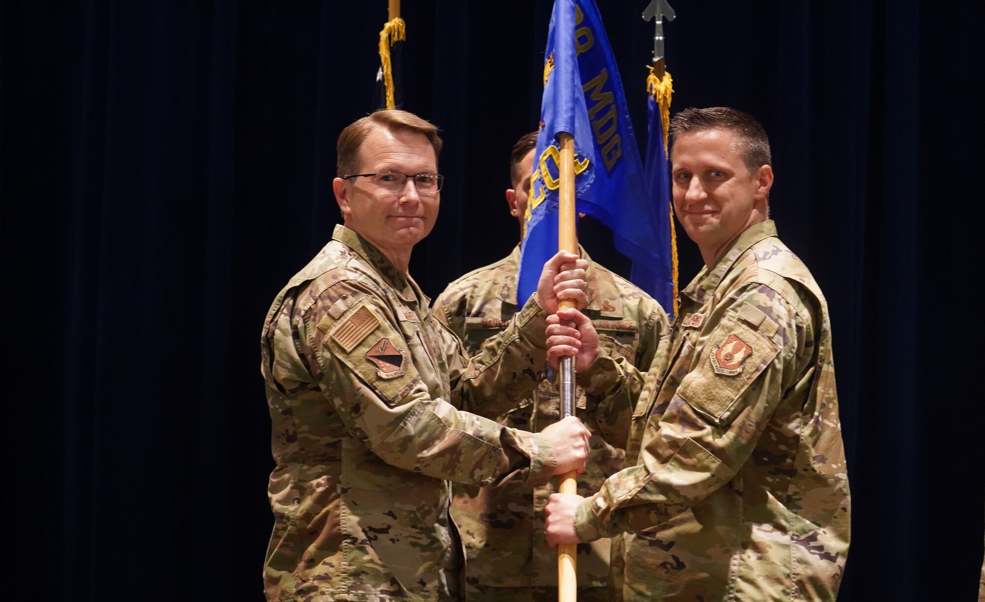 Harrell presents the 88th Healthcare Operations Squadron guidon to Palmer.