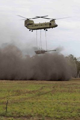 Helicopter hovers over a field