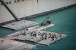 Landing pads and equipment beside a ship