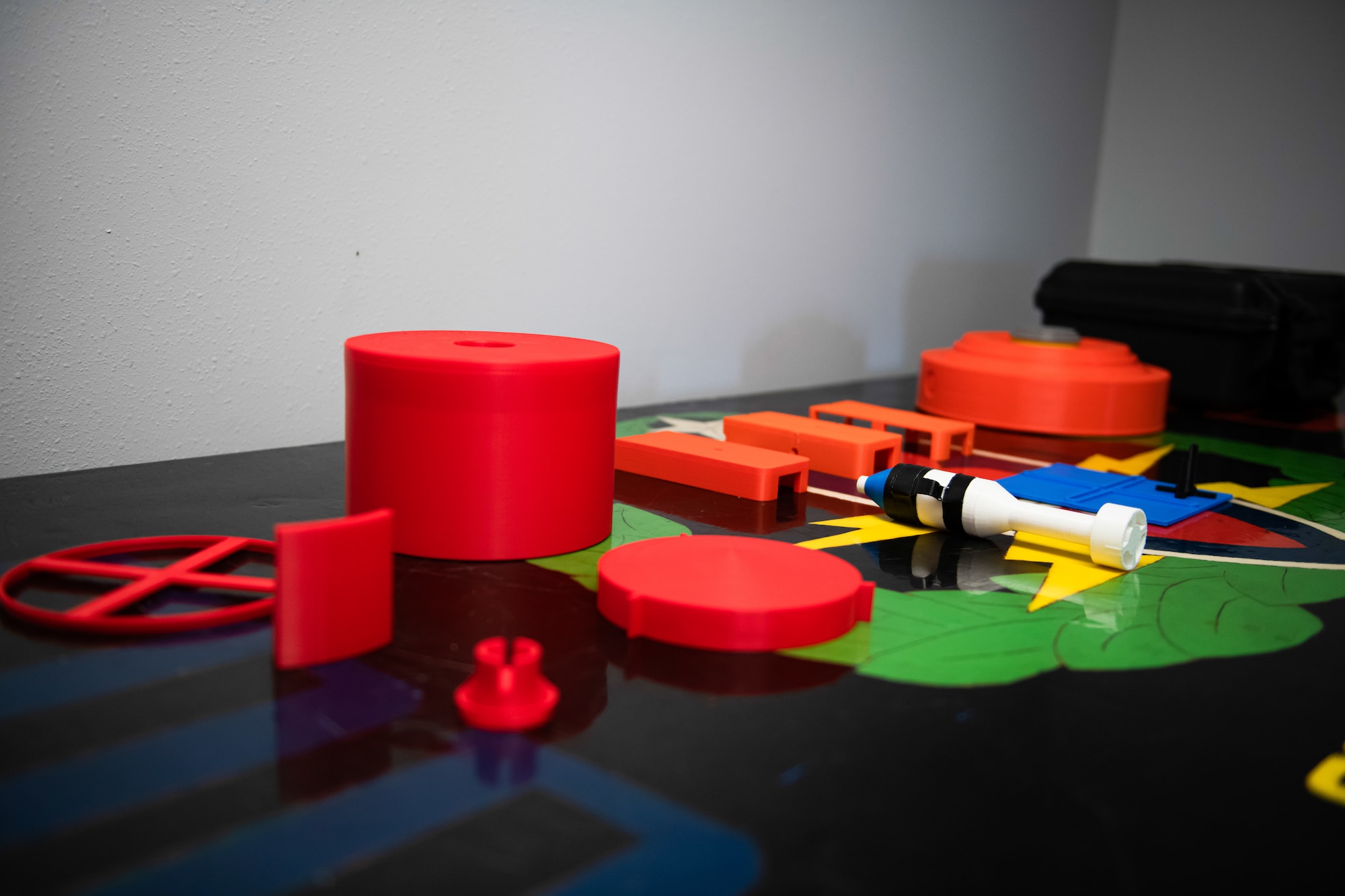 3D printed training aids are displayed on a table.