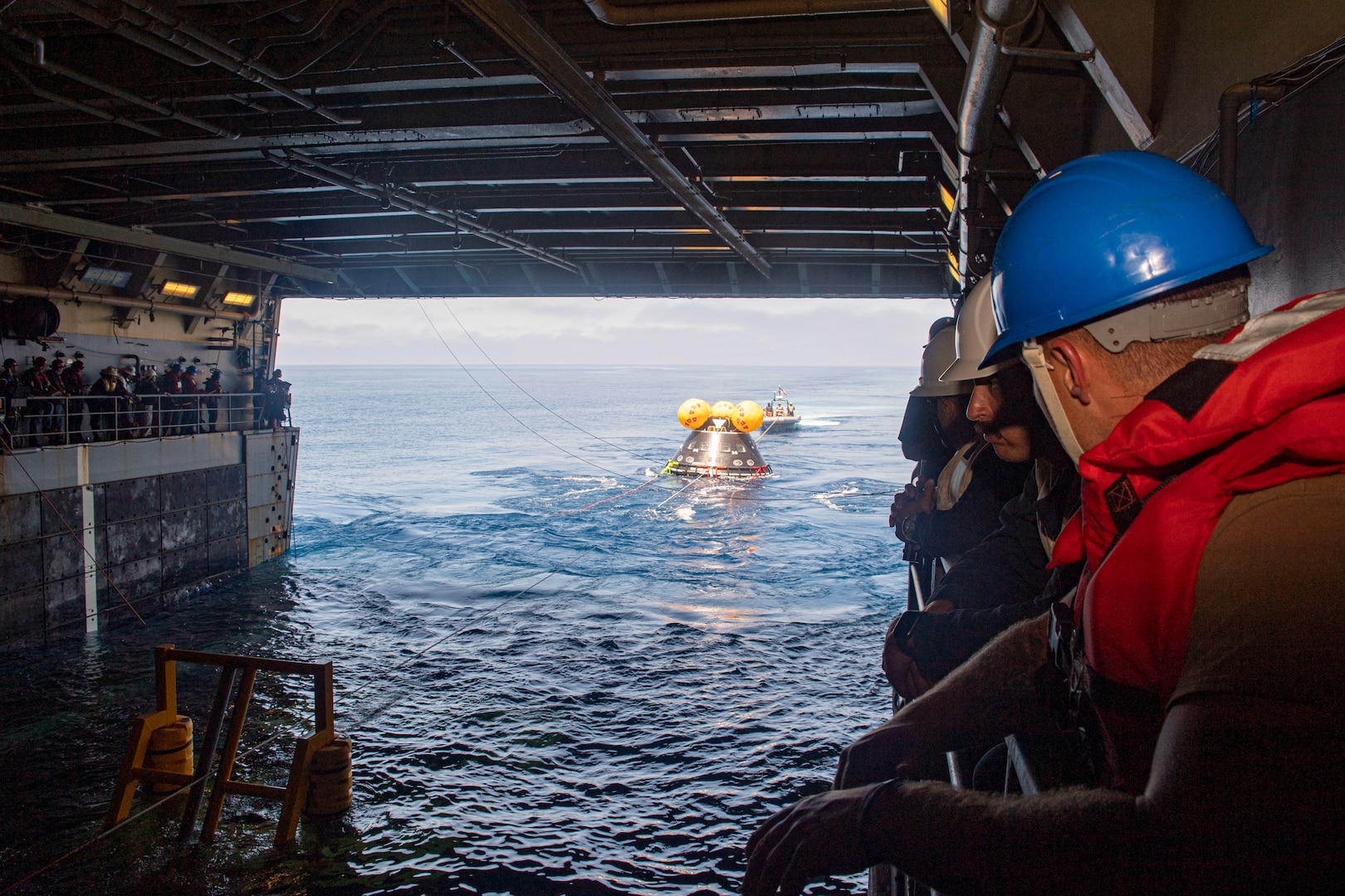 Sailors aboard amphibious transport dock ship USS John P. Murtha (LPD 26) train alongside NASA on proper line-handling for the Vehicle Advanced Demonstrator for Emergency Recovery, “VADR”, during Underway Recovery Test (URT) 10, July 26, 2023.