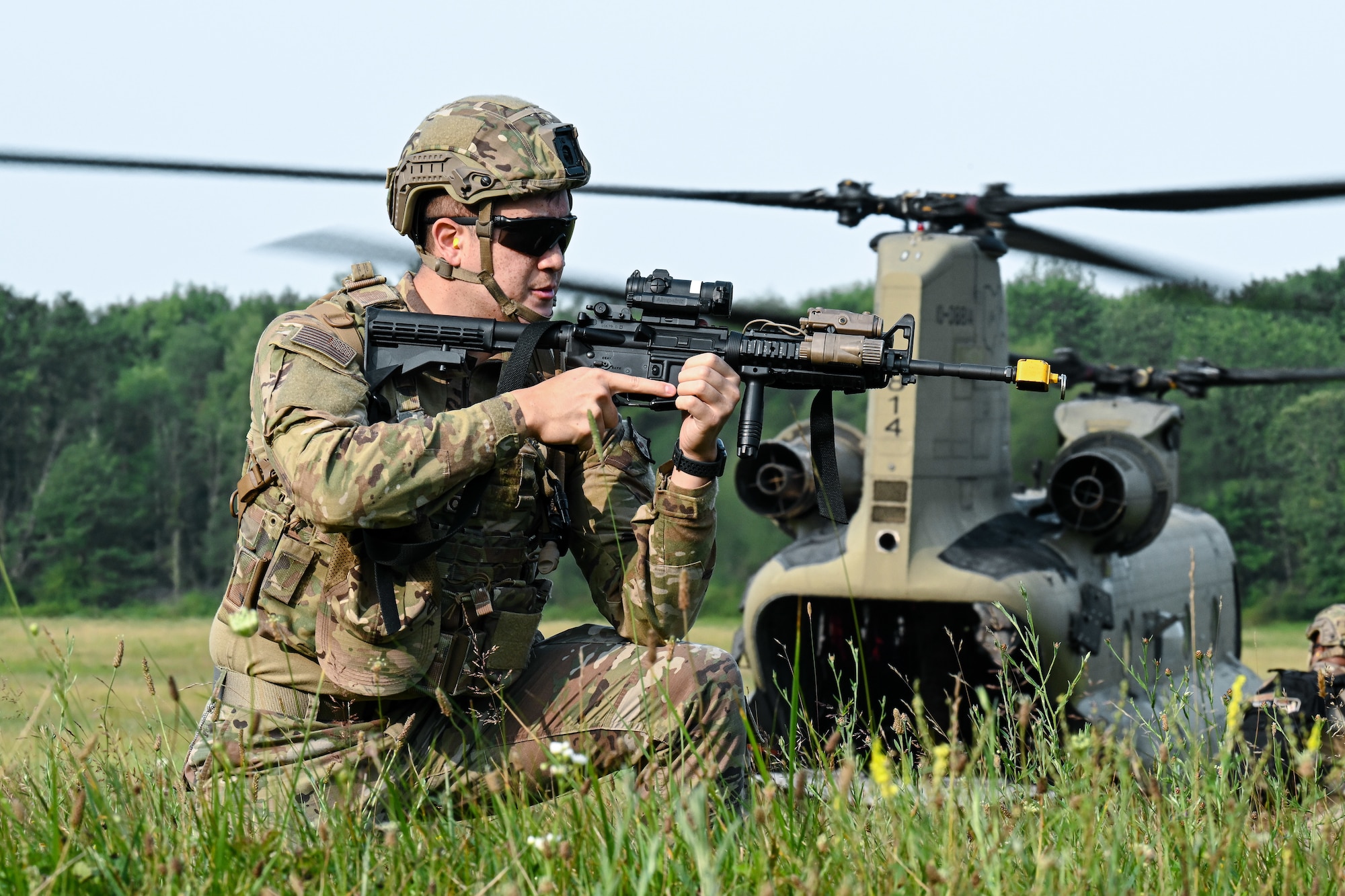 Staff Sgt. Anthony Piper, a 910th Security Forces Squadron Defender, guards an Ohio National Guard CH-47 Chinook helicopter after disembarking the aircraft on July 25, 2023, at Camp James A. Garfield Joint Military Training Center, Ohio.