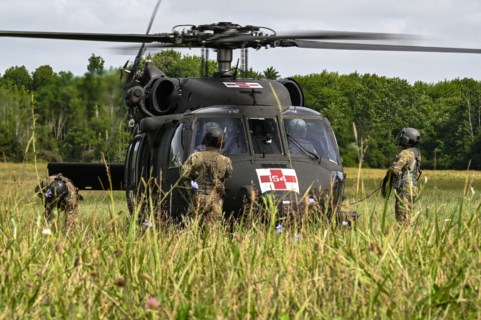 Members from the 3rd Batallion, 238th Air Regiment, perform pre-flight checks on a UH-60L Black Hawk medevac helicopter prior to takeoff on July 25, 2023, at Camp James A. Garfield Joint Military Training Center, Ohio.