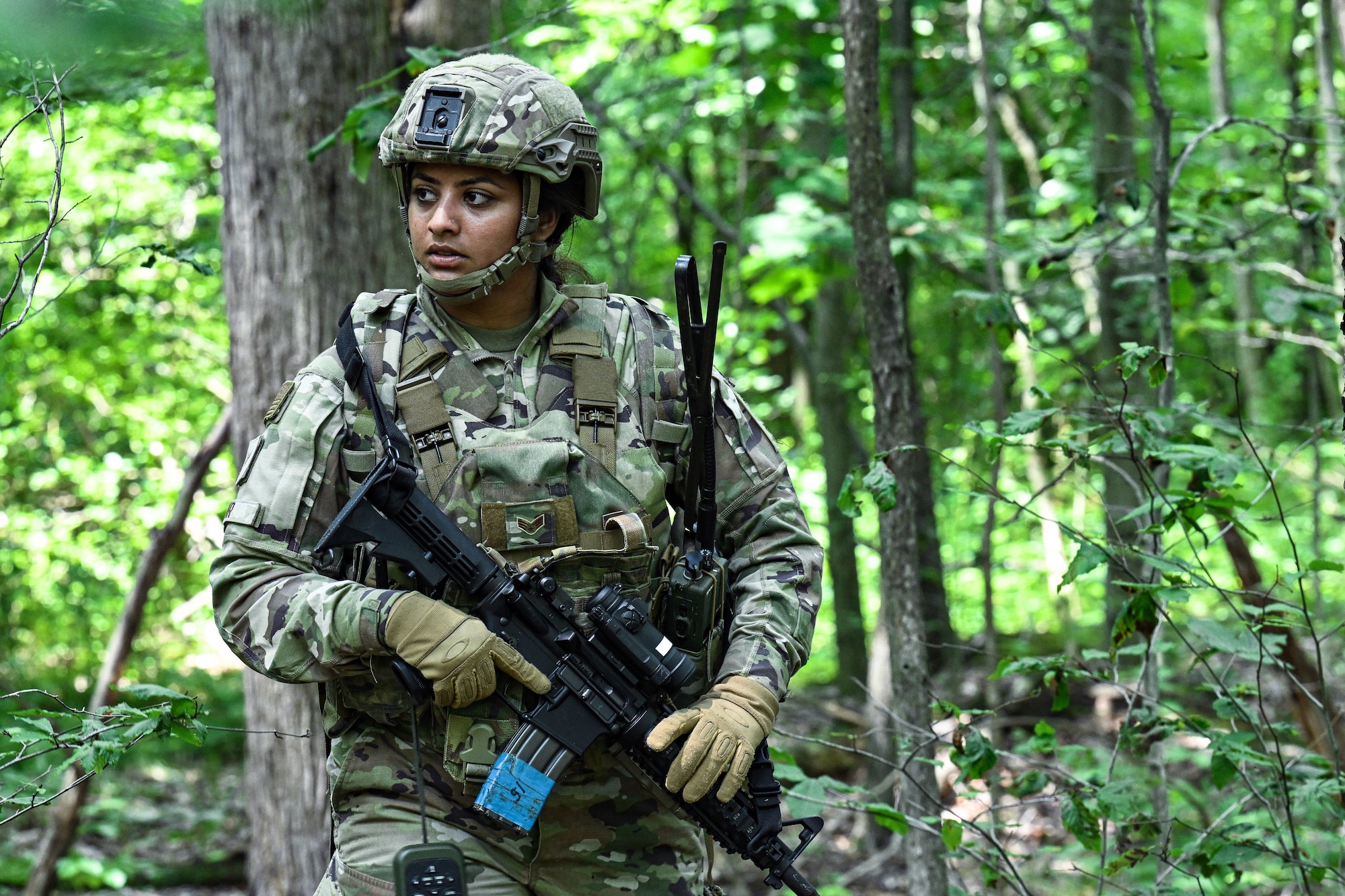 Senior Airman Manjinder Kaur, a 910th Security Forces Squadron Defender, walks through the woods during a land navigation exercise on July 25, 2023, at Camp James A. Garfield Joint Military Training Center, Ohio.