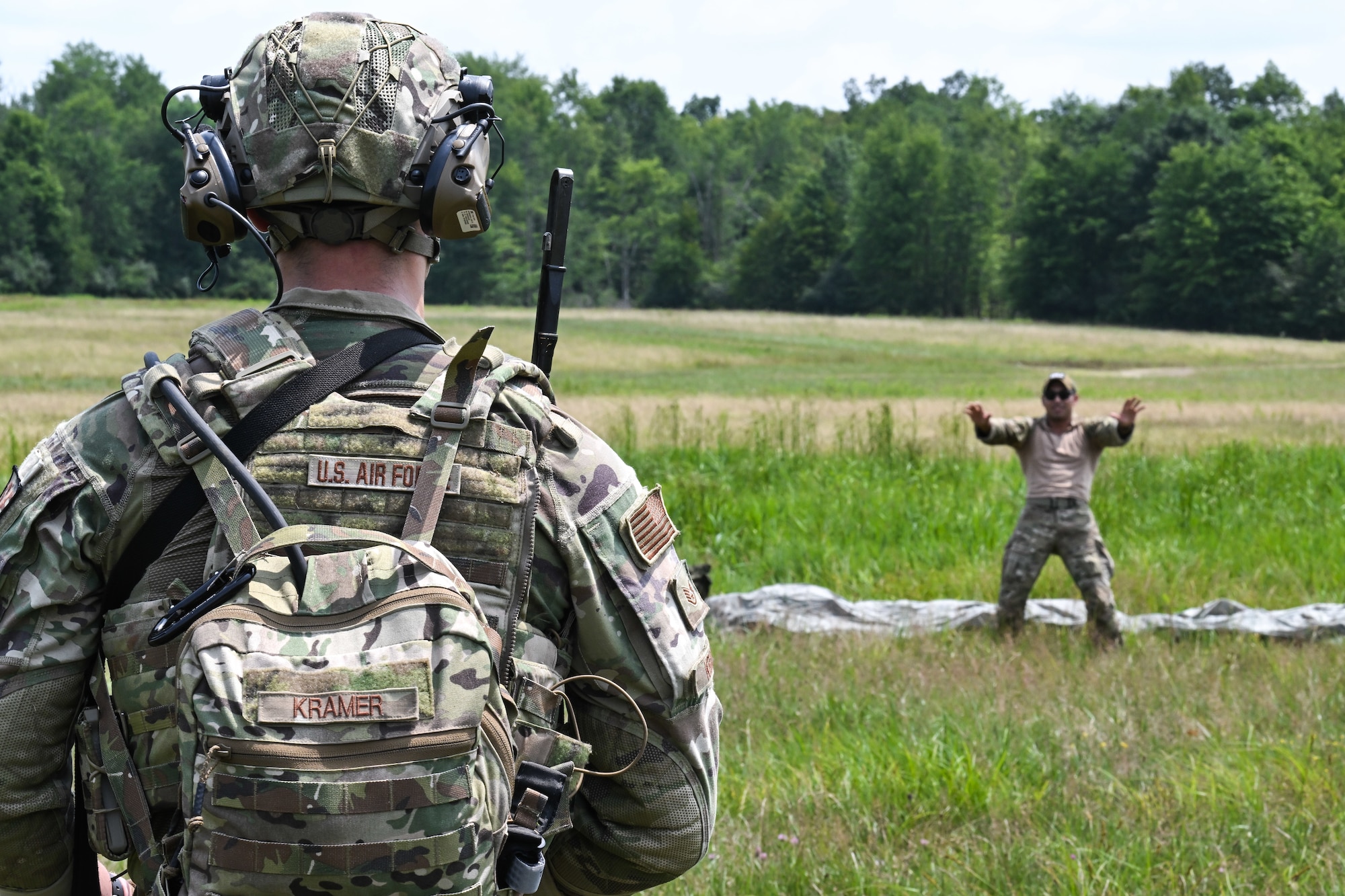 Staff Sgt. Nathaniel Kramer, a 910th Security Forces Squadron Defender, interacts with a simulated civilian during an exercise on July 25, 2023, at Camp James A. Garfield Joint Military Training Center, Ohio.