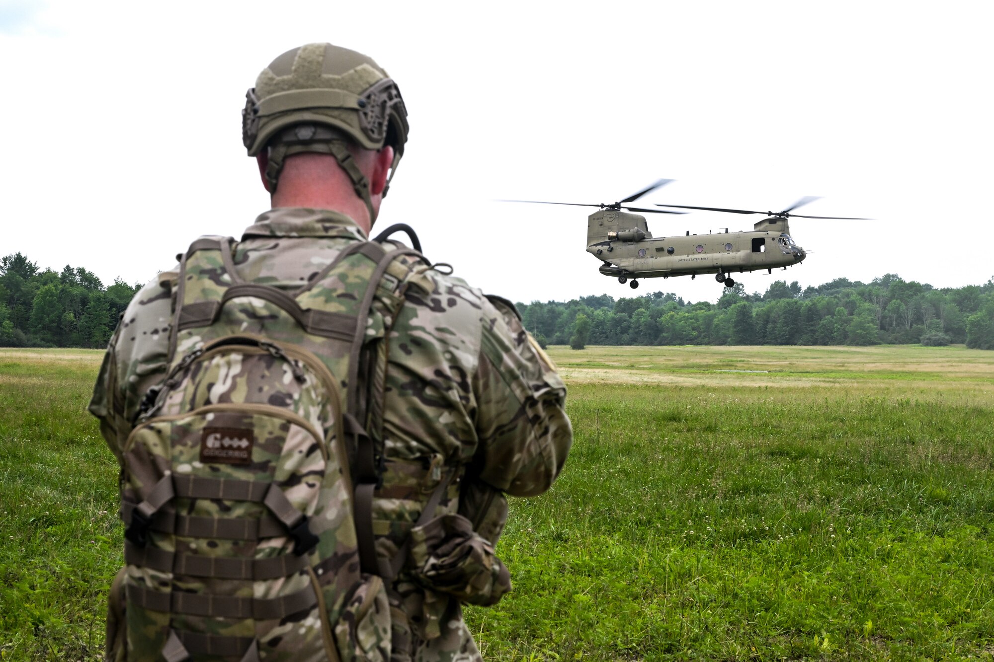 Senior Master Sgt. Daniel Chase, Air Force Reserve Command Integrated Defense Leadership Course chief, watches an Ohio National Guard CH-47 Chinook helicopter land on July 25, 2023, at Camp James A. Garfield Joint Military Training Center, Ohio.