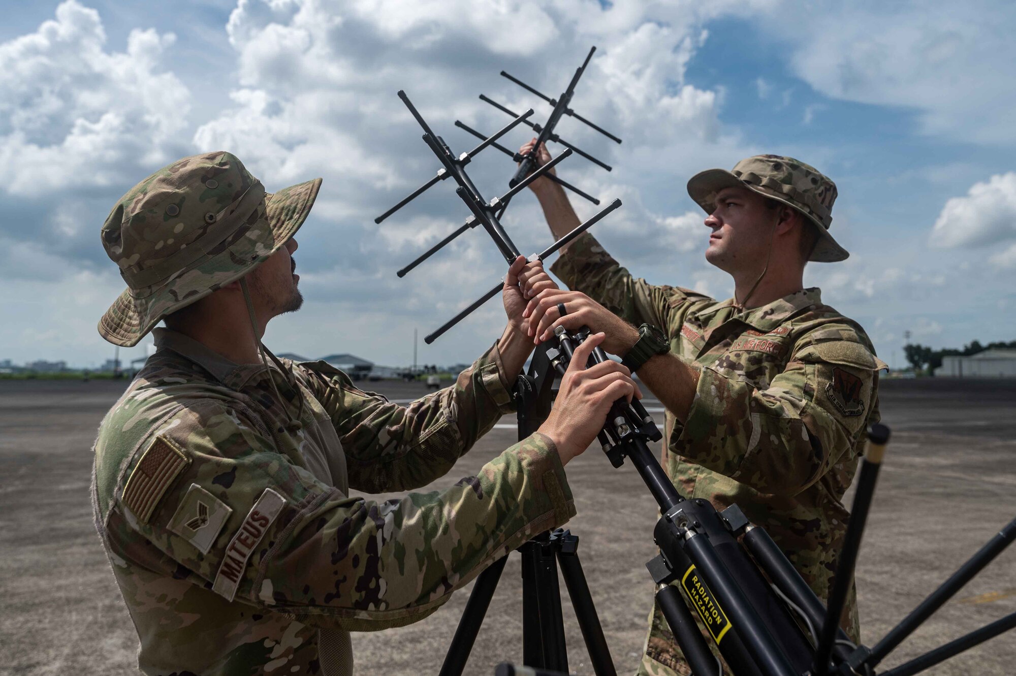 U.S. Air Force Staff Sgt. Dustin Bennet and Senior Airman Edward Mateus, 355th Communication Squadron cyber defense operation technicians, assemble a 2011 satellite communication antenna during Cope Thunder 23-2 on the South ramp of Clark Air Base, Philippines, July 11, 2023. Cope Thunder 23-2 was an exercise that built relationships that bridged the language barrier and enhanced the U.S. and the Philippines’ collective ability to address the most pressing security challenges. (U.S. Air Force photo by Airman 1st Class Jhade Herrera)