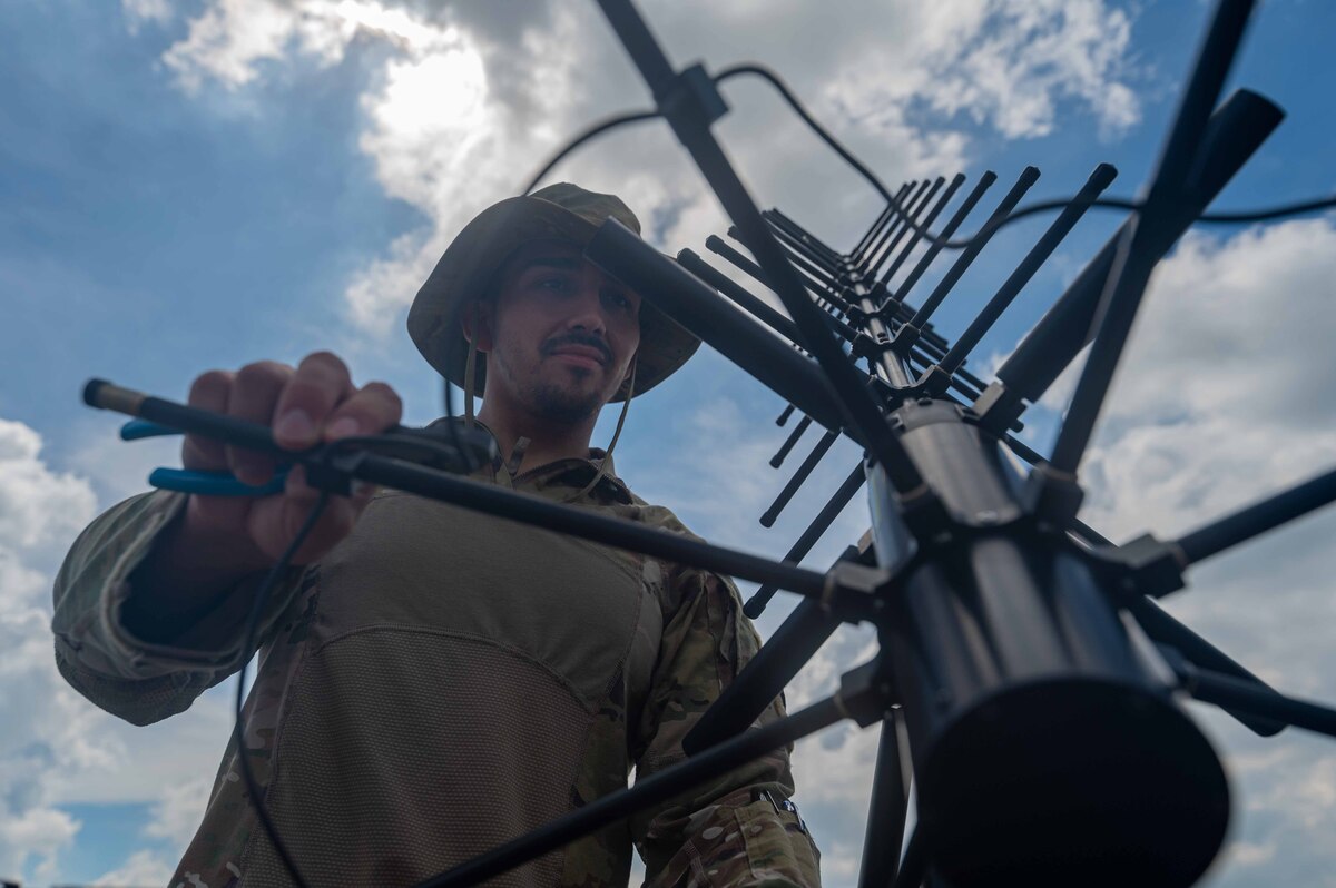 U.S. Air Force Senior Airman Edward Mateus, 355th Communication Squadron cyber defense operation technician, opens a 2011 satellite communication antenna on the South ramp of Clark Air Base, Philippines, in support of Cope Thunder 23-2, July 11, 2023. Bilateral training exercises like Cope Thunder 23-2 helped to reinforce the U.S.’ commitment to peace and prosperity in the region. (U.S. Air Force photo by Airman 1st Class Jhade Herrera)