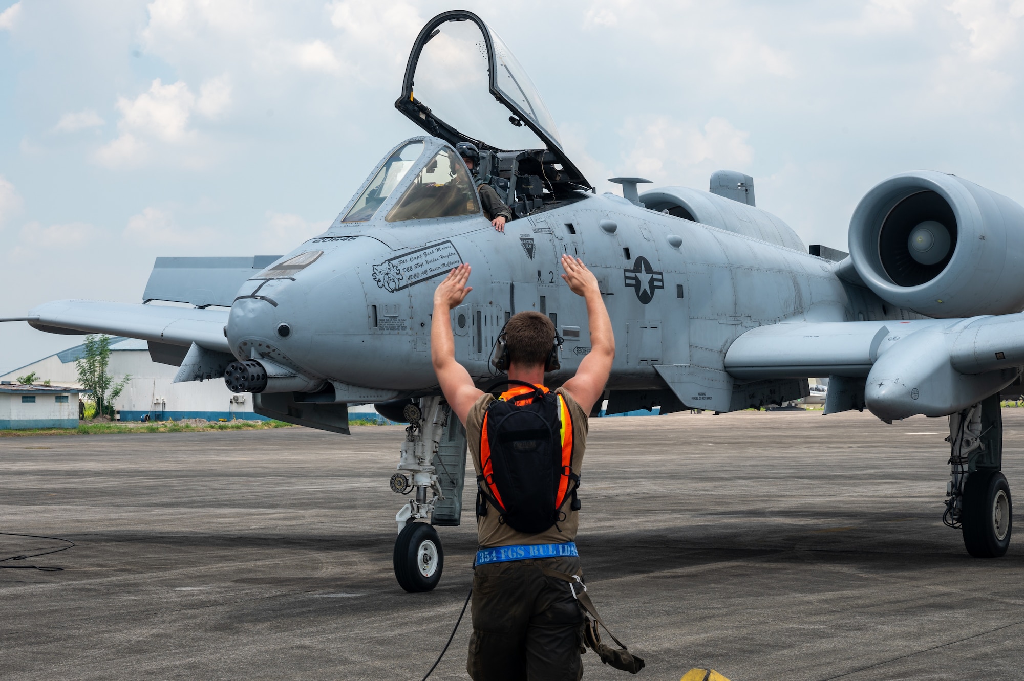 A U.S. Air Force Airman, assigned to Davis-Monthan Air Force Base, Arizona marshals an A-10C Thunderbolt II in support of Cope Thunder 23-2 operations at Clark Air Base, Philippines, July 7, 2023. Cope Thunder 23-2 was an exercise with the goal to improve regional security and protect a free and open Indo-Pacific.