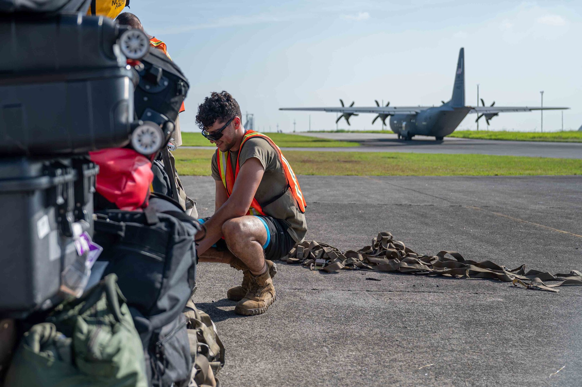 U.S. Air Force Staff Sgt. Harry Edmondson, 355th Logistics readiness Squadron air transportation function supervisor, prepares luggage for transportation on the South ramp of Clark Air Base, Philippines, July 10, 2023. Edmonson took part in exercise Cope Thunder 23-2 to increase readiness, improve interoperability, and mutual defense capabilities. (U.S. Air Force photo by Airman 1st Class Jhade Herrera)
