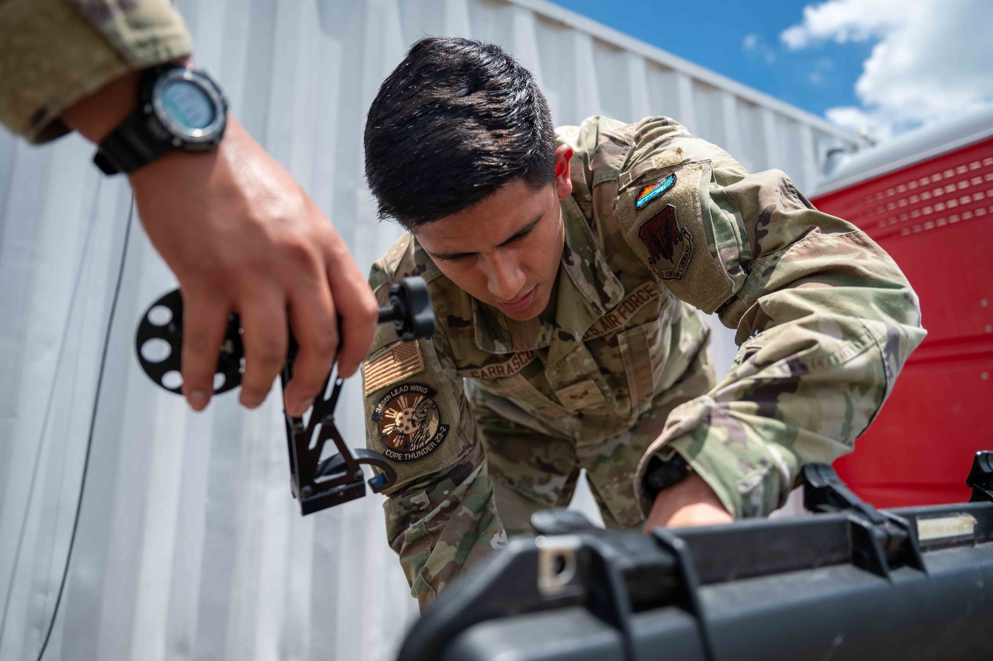 A U.S. Air Force Airman packs up communication equipment during exercise Cope Thunder 23-2 on the South ramp of Clark Air Base, Philippines, July 19, 2023. Cope Thunder builds upon existing U.S. relations with the Philippines. It demonstrates U.S. resolve to promote regional security and cooperation. (U.S. Air Force photo by Airman 1st Class Jhade Herrera)