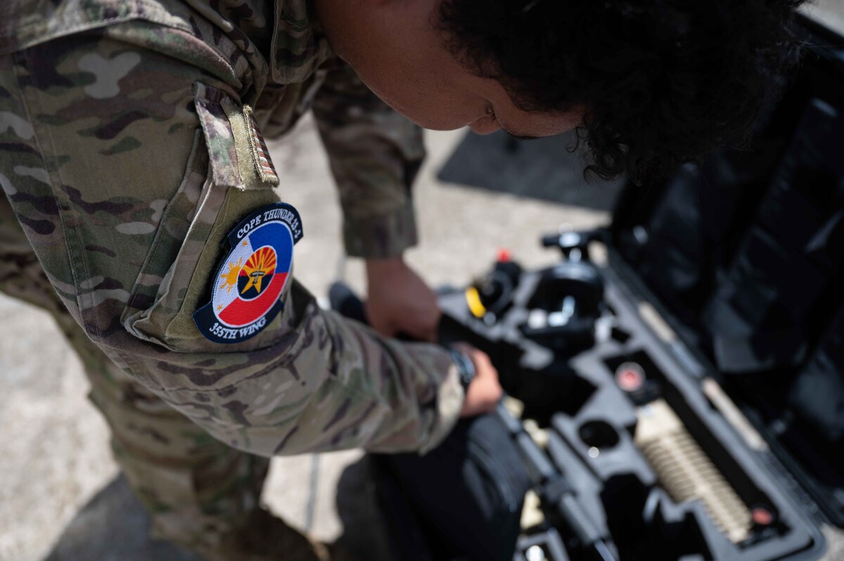 A U.S. Air Force Airman packs up communication equipment during exercise Cope Thunder 23-2 on the South ramp of Clark Air Base, Philippines, July 19, 2023. Cope Thunder gives us an opportunity to exercise combined fighter operations and enable tactical units to operate together. (U.S. Air Force photo by Airman 1st Class Jhade Herrera)