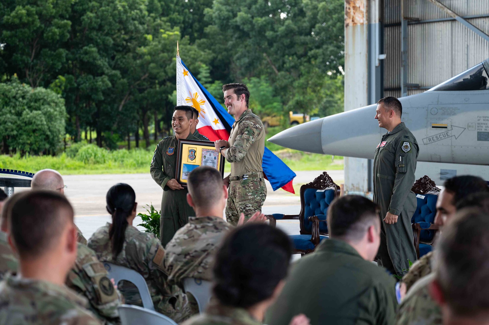 U.S. Air Force personnel receive awards from Philippine Air Force personnel during the closing ceremony of exercise Cope Thunder 23-2 on the South ramp of Clark Air Base, Philippines, July 21, 2023. Cope Thunder builds upon existing U.S. relations with the Philippines. It demonstrates U.S. resolve to promote regional security and cooperation. (U.S. Air Force photo by Airman 1st Class Jhade Herrera)