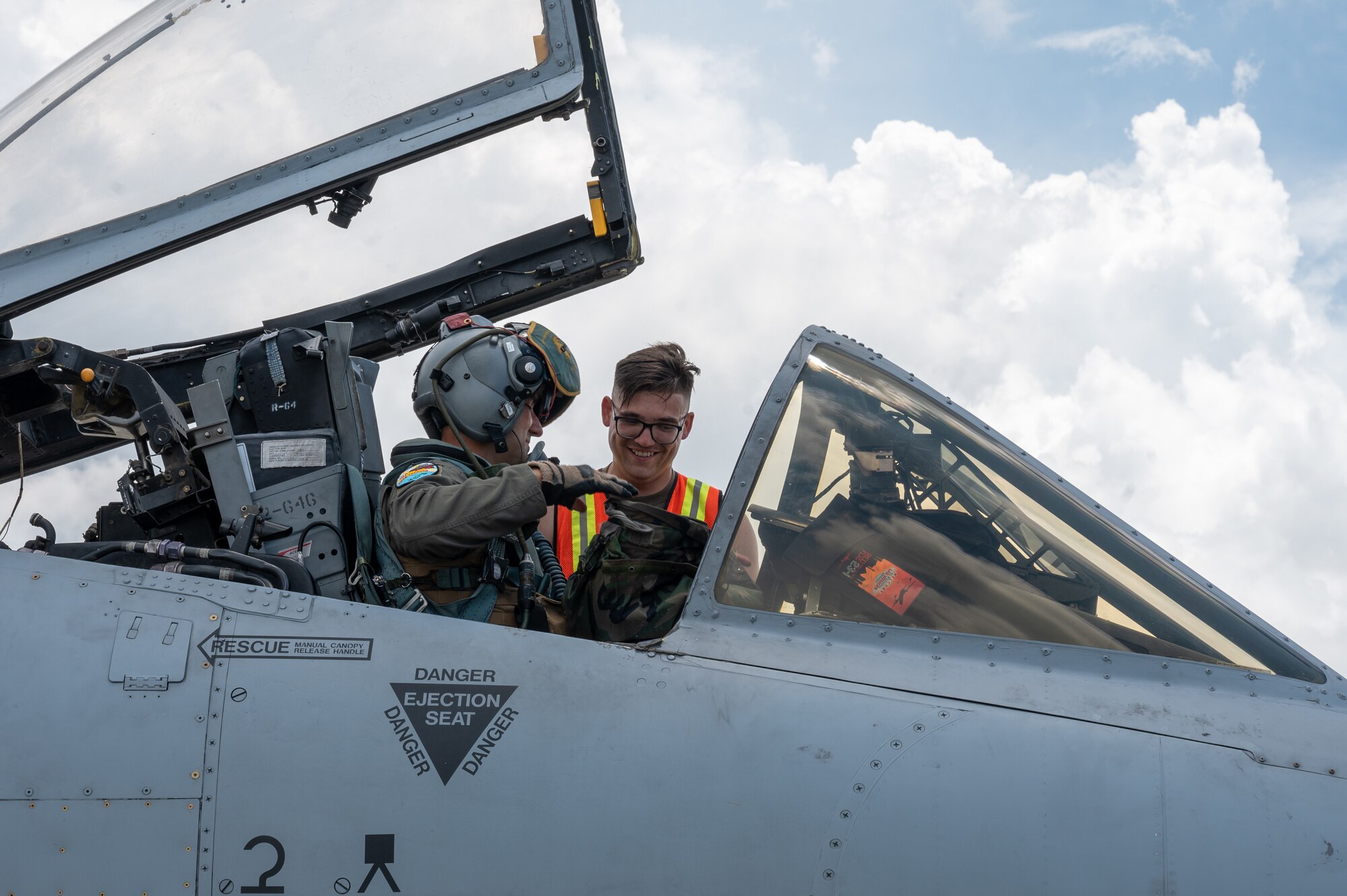 A U.S. Air Force Airman, assigned to Davis-Monthan Air Force Base, Arizona helps a pilot with his gear in support of Cope Thunder 23-2 at Mactan, Philippines, July 11, 2023. Cope Thunder 23-2 provided a unique opportunity for the service members to train together, increasing the U.S.’ and the Philippines’ ability to work together.