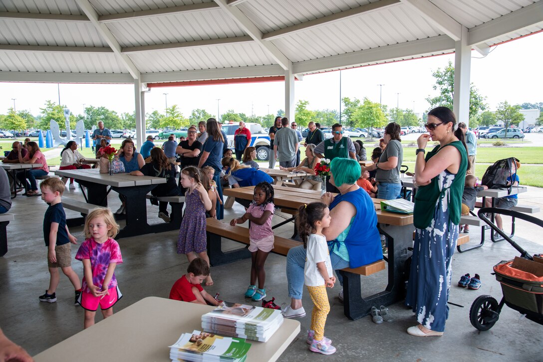 A large group of children and adults in a pavilion.