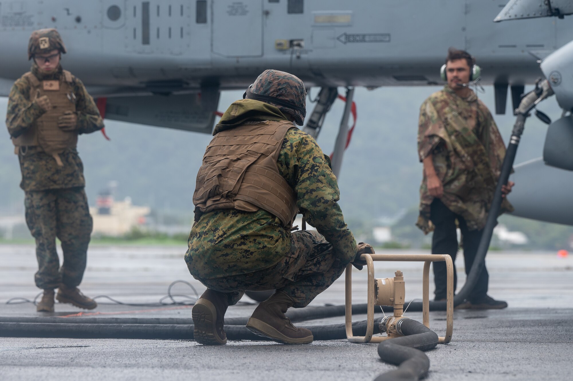 A U.S. Marine Corps Marine, assigned to Marine Wing Support Squadron 373, assists during a forward arming and refueling exercise for Cope Thunder 23-2  at Subic Bay International Airport, Philippines, July 15, 2023. Cope Thunder 23-2 provided valuable training to aircrews allowing joint foreign forces to work together and improve interoperability. (U.S. Air Force photo by Senior Airman Vaughn Weber)