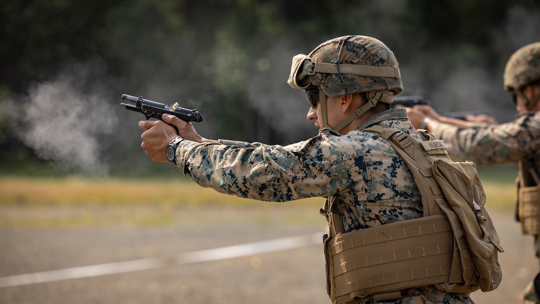 U.S. Marines participate in a pistol shooting competition during the Force Headquarters Group Super Squad Competition at Joint Base Elmendorf-Richardson, Alaska, July, 24, 2023. During the multi-day competition, reserve units from all across the Marine Corps, exercised their technical and tactical proficiencies by competing in events that highlighted offensive/defensive operations, patrolling techniques, combat marksmanship, physical endurance and small unit leadership.