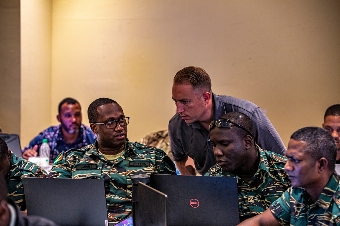 U.S. Marine Corps Staff Sgt. David "Ryne" Osbourne, a cyber operator, with Alpha Company, 6th Communications Battalion, Force Headquarters Group, Marine Forces Reserve, leads a class on Security Onion with multiple partner nations cyber teams during Tradewinds 23 in Georgetown, Guyana, July 21, 2023. Tradewinds is a U.S. Southern Command-sponsored exercise designed to strengthen partnerships and interoperability, promote human rights, as well as increase all participants training capacity and to mitigate, plan for and respond to crisis and security threats. Osbourne is a native of Huntsville, Alabama and currently works as a Cyber Systems Engineering Manager for Nothrop Grumman Corporation.