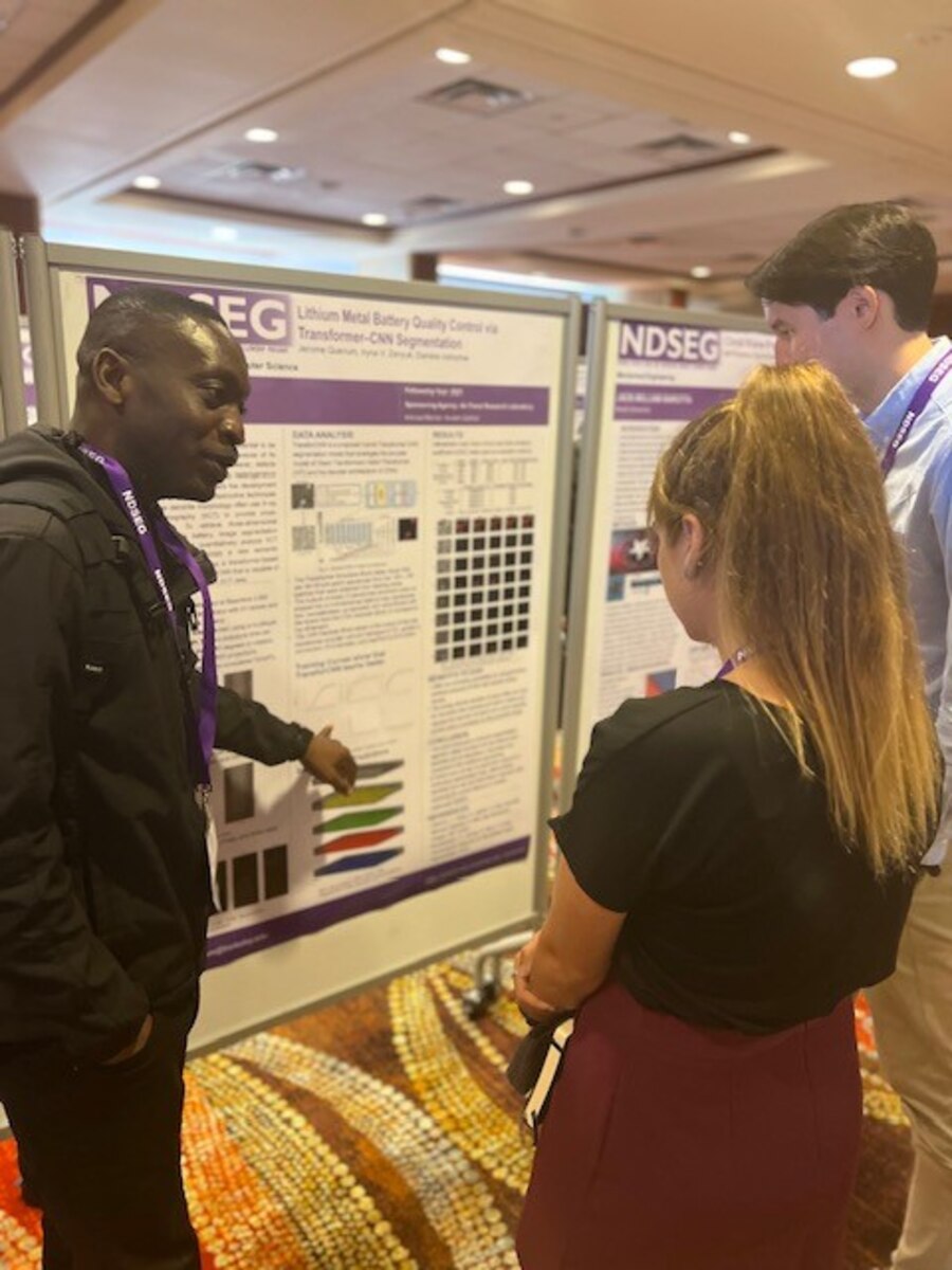 Jerome Quenum, a fellow with Air Force Research Laboratory’s, or AFRL, Air Force Office of Scientific Research, or AFOSR, presents his research in computer science with his peers at the poster exhibit hall Aug. 1, 2023, during the National Defense Science and Engineering Graduate Fellowship, or NDSEG, at the Hilton Palacio del Rio in San Antonio, Texas. NDSEG fellows presented their work to DOD evaluators, peers and mentors, and discussed the research conducted during their fellowship. (U.S. Air Force photo / Brianna Hodges)