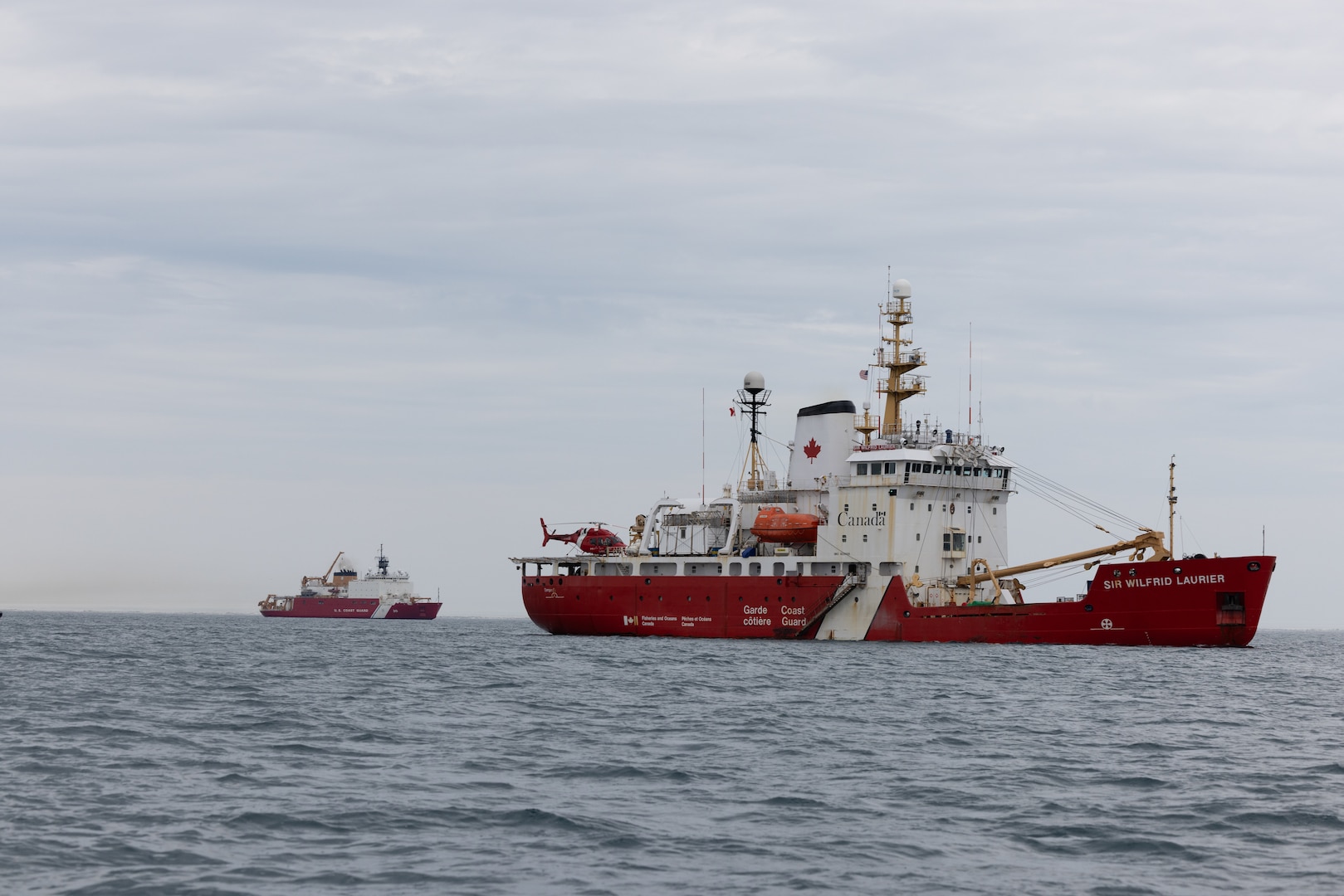 Coast Guard Cutter Healy (WAGB 20) and crew conduct formation steaming exercises with Candian Coast Guard Ship Sir Wilfrid Laurier and crew in the Beaufort Sea, July 28, 2023. The crew conducted a passenger exchange with the Sir Wilfrid Laurier off the coast of Utqiagvik, Alaska. (U.S. Coast Guard photo by Petty Officer 1st Class Michael Underwood)