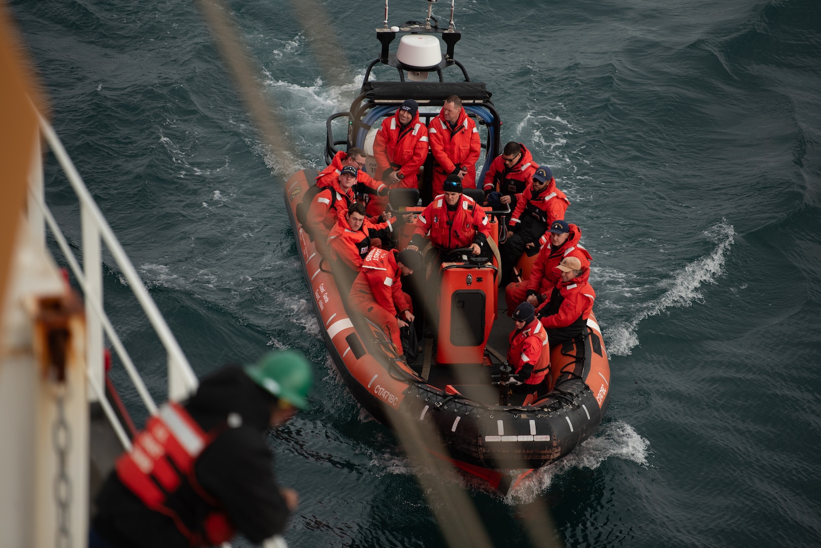 Coast Guard Cutter Healy (WAGB 20) crew members depart on a small boat embarked on the Canadian Coast Guard Ship Sir Wilfrid Laurier in the Beaufort Sea, July 28, 2023. The crew conducted a passenger exchange with the CCGS Sir Wilfrid Laurier and crew off the coast of Utqiagvik, Alaska. (Coast Guard photo by Petty Officer 3rd Class Briana Carter)