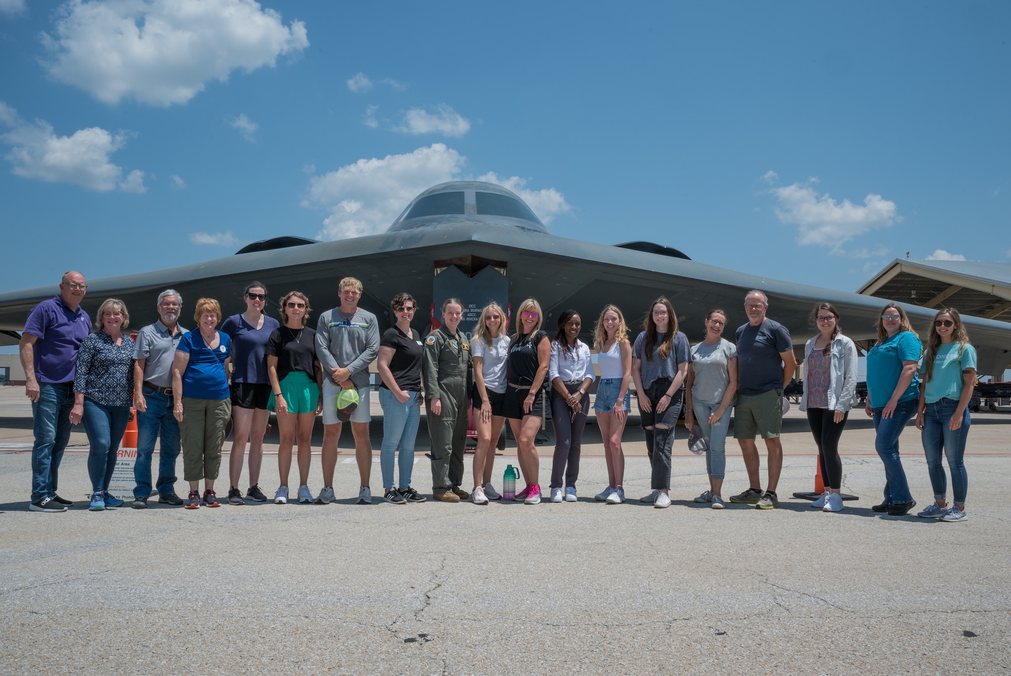 Members of the Ninety-Nines Greater Kansas City Chapter stand for a photo in front of the B-2 Spirit Stealth Bomber at Whiteman Air Force Base, Missouri, June 22, 2023. The Ninety-Nines are an international organization of women pilots that promotes the advancement of aviation through education, scholarships and mutual support. (U.S Air Force photo by Senior Airman Christina Carter)