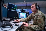 Alaska Air National Guard Senior Airman Kenyon DePriest, 176th Air Defense Squadron surveillance technician, monitors Alaska airspace March 14, 2023, in the Regional Air Operations Center at Joint Base Elmendorf-Richardson, Alaska. DePriest competed in the run/bike/ski World Winter Triathlon Championships in Skeikampen, Norway, in March 2023.