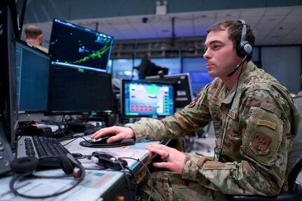 Alaska Air National Guard Senior Airman Kenyon DePriest, 176th Air Defense Squadron surveillance technician, monitors Alaska airspace March 14, 2023, in the Regional Air Operations Center at Joint Base Elmendorf-Richardson, Alaska. DePriest competed in the run/bike/ski World Winter Triathlon Championships in Skeikampen, Norway, in March 2023.