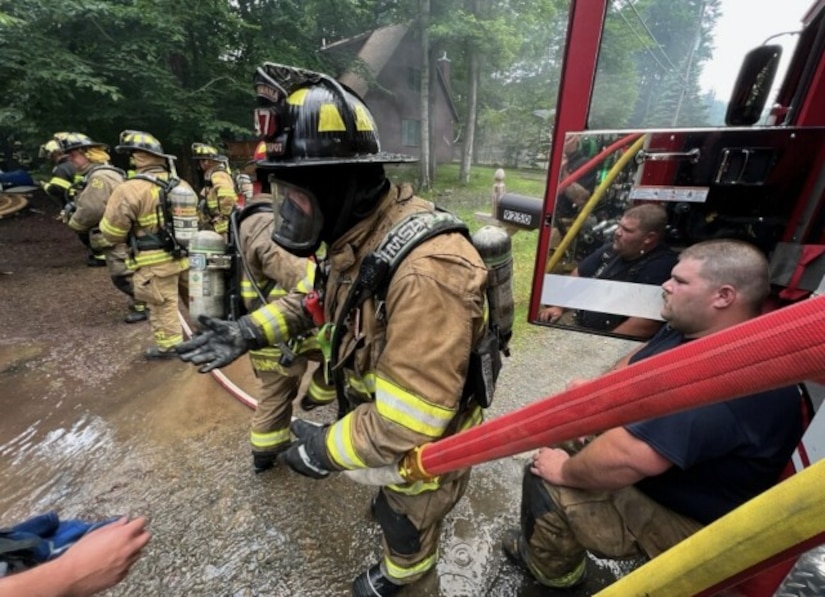 Photo of Miller providing emergency services in the community alongside other members of the Tobyhanna Army Depot Fire & Emergency Services team.