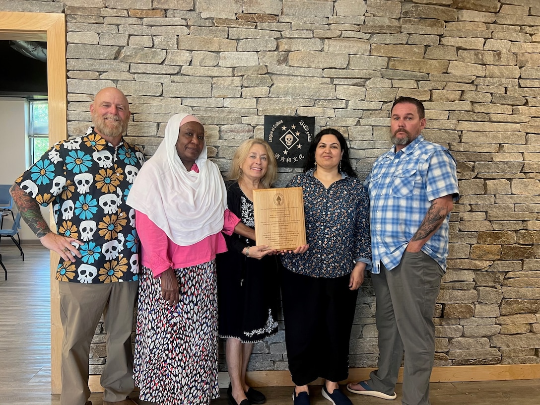 Marine Raider Regiment Language Program staff pose for a photo with the 2023 U.S. Special Operations Command “Most Improved Language Program of the Year” award. The MRR Language Program serves as an amplifier for the basic language training that Marine Raiders receive during their accession pipeline. Throughout their service, Marine Raiders will work with the MRR Language Program on sustainment and advancement of their foreign language skills through courses, real-world training, and immersive interactions. (U.S. Marine Corps courtesy photo)