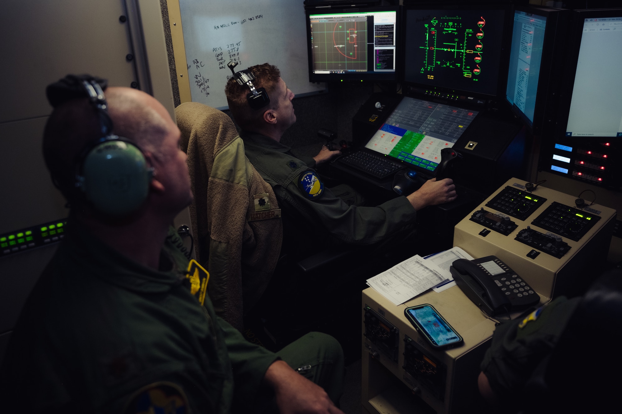 U.S. Air Force Maj. Jerome Robinson, 29th Attack Squadron MQ-9 instructor pilot, left, observes U.S. Air Force Lt. Col. Nicholas Hatcher, 49th Wing chief of safety, as he conducts his pre-flight check during Agile Combat Employment Grand Warrior at Holloman Air Force Base, New Mexico, July 21, 2023. This exercise marks the first time the 49th Wing performed an entire mission under complete Satellite Communication control operated solely by Mission Control Element personnel the entire time in unfamiliar airspace.  (U.S. Air Force photo by Senior Airman Antonio Salfran)