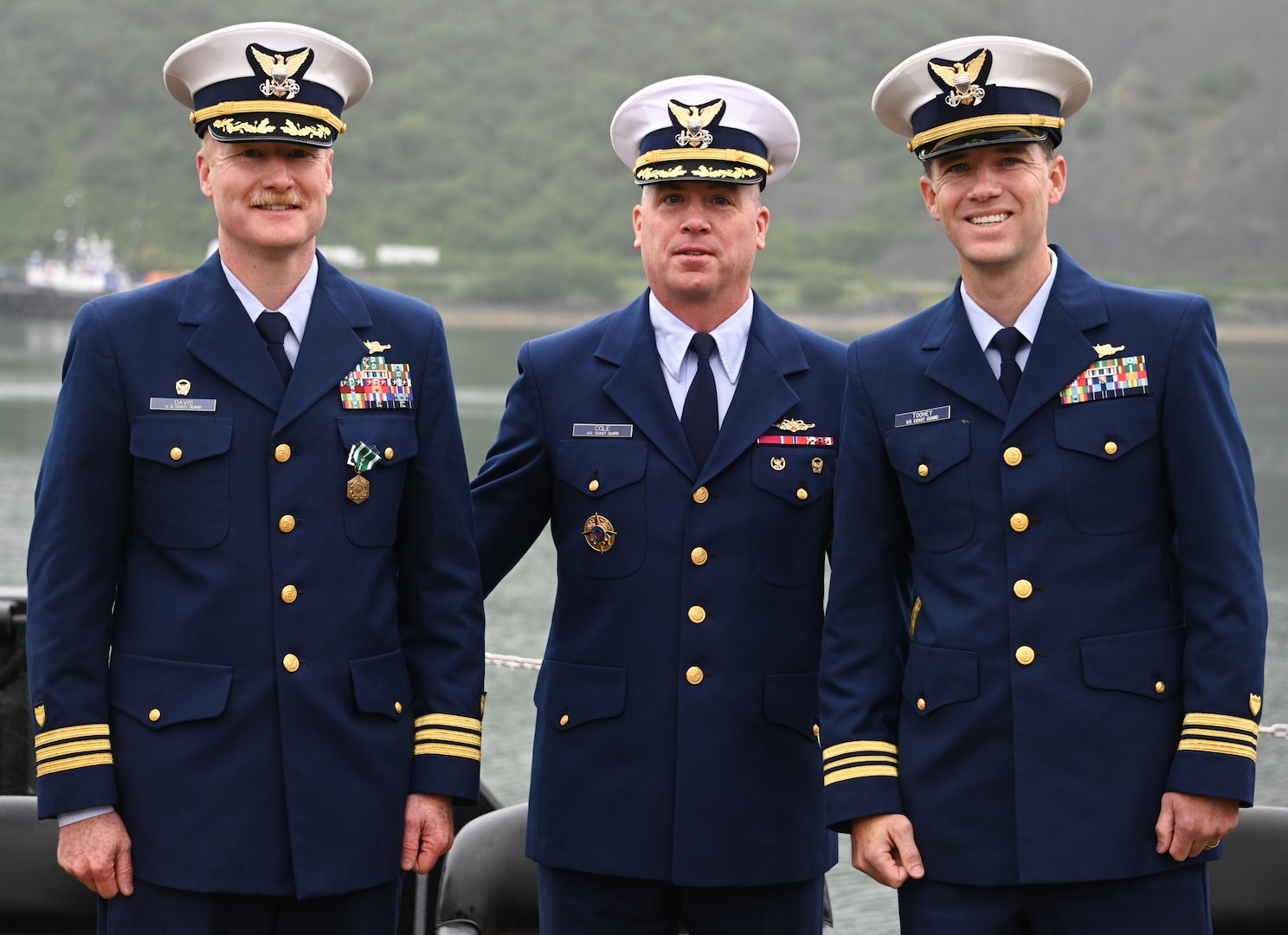 From left, U.S. Coast Guard Cdr. Daniel Davis, Capt. John Cole, Chief of Staff, Coast Guard 17th District, and Lt. Cmdr. James Toohey, commanding officer, Cypress, pose for a photo during a change-of-command ceremony at Base Kodiak, Aug. 3, 2023. The change-of-command ceremony is a historic Coast Guard and Naval tradition, which has remained unchanged for centuries and includes the reading of the command orders in the presence of all unit crewmembers. U.S. Coast Guard photo by Petty Officer 3rd Class Ian Gray.
