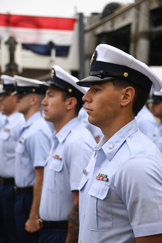 Coast Guard Cutter Cypress personnel stand at parade rest during a change-of-command ceremony held at Base Kodiak in Kodiak, Alaska, Aug. 3, 2023. Base Kodiak is the largest land installation of the Coast Guard and serves as the senior Mission Support touchstone for Coast Guard operations within the 17th District across Alaska, standing shoulder-to-shoulder with its operational partners to ensure the delivery of professional, responsive and cost-effective services to the American public. U.S. Coast Guard photo by Petty Officer 3rd Class Ian Gray.